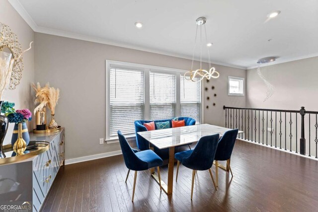 dining area with crown molding, a healthy amount of sunlight, dark hardwood / wood-style flooring, and an inviting chandelier