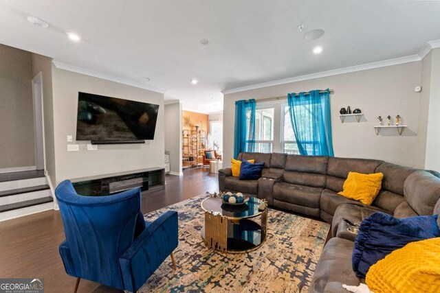 living room with crown molding and dark hardwood / wood-style floors