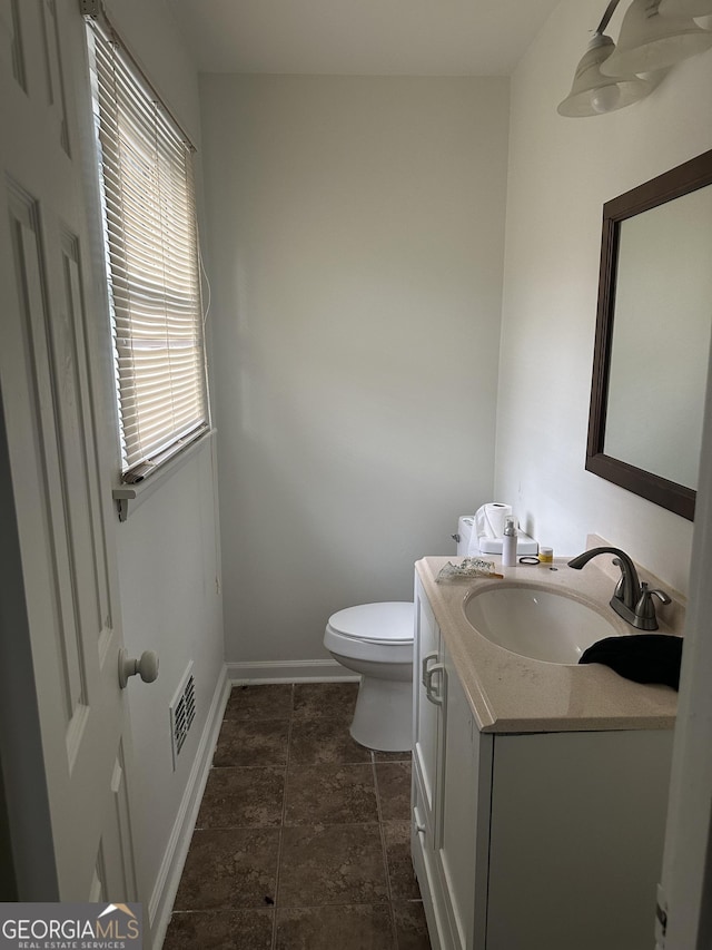 bathroom with toilet and vanity