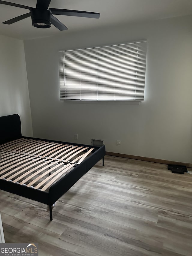 bedroom featuring ceiling fan and light hardwood / wood-style floors