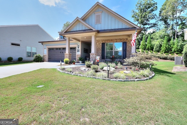 craftsman-style home with covered porch, a garage, and a front lawn