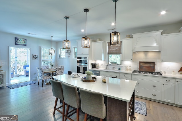 kitchen with a center island, appliances with stainless steel finishes, and white cabinets