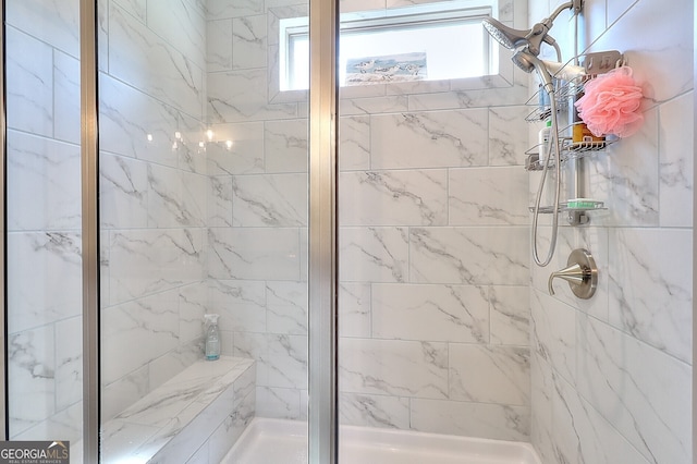 bathroom featuring a shower with door