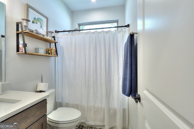 bathroom with vanity, toilet, and walk in shower