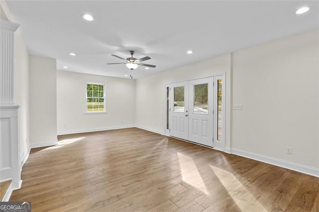 foyer entrance with ceiling fan and light hardwood / wood-style flooring