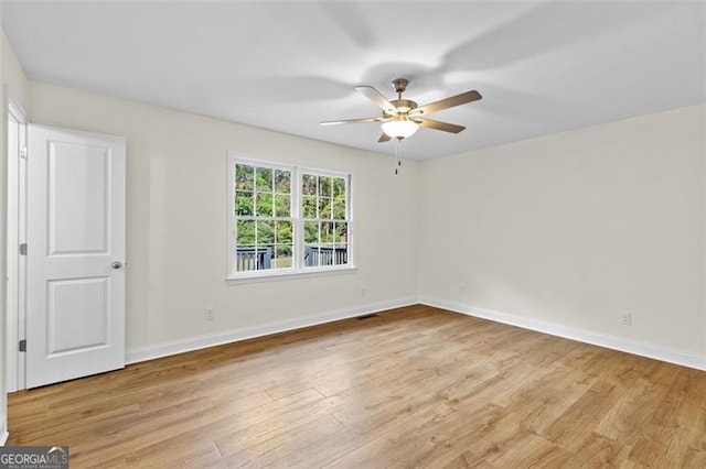 unfurnished room featuring ceiling fan and light wood-type flooring