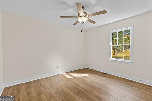 empty room featuring light wood-type flooring and ceiling fan