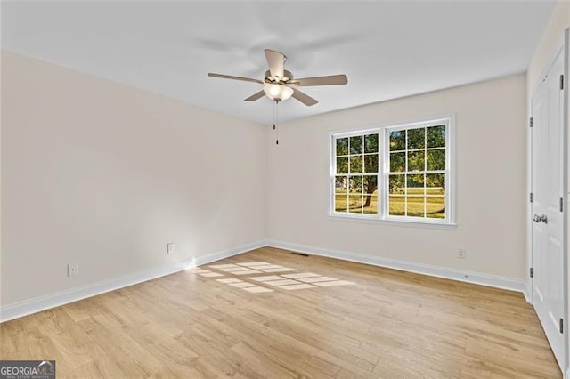 unfurnished room featuring light wood-type flooring and ceiling fan