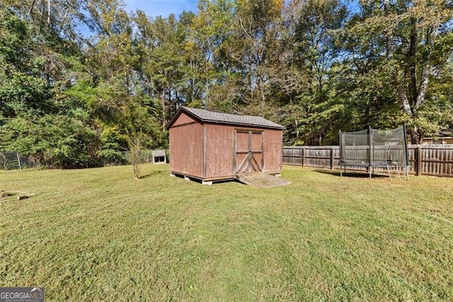 view of yard with a storage unit and a trampoline