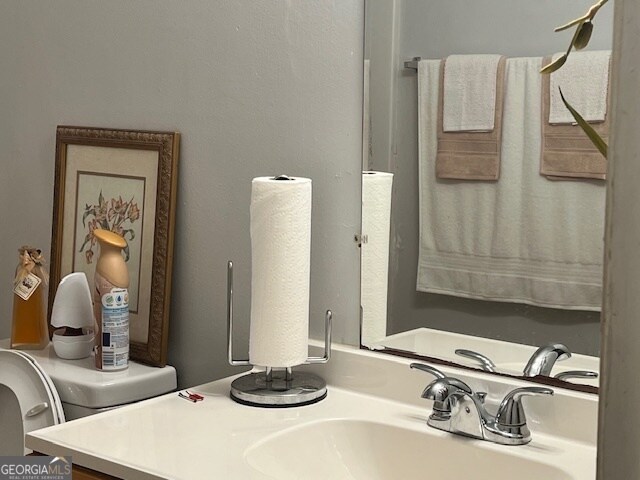 bathroom featuring toilet and vanity