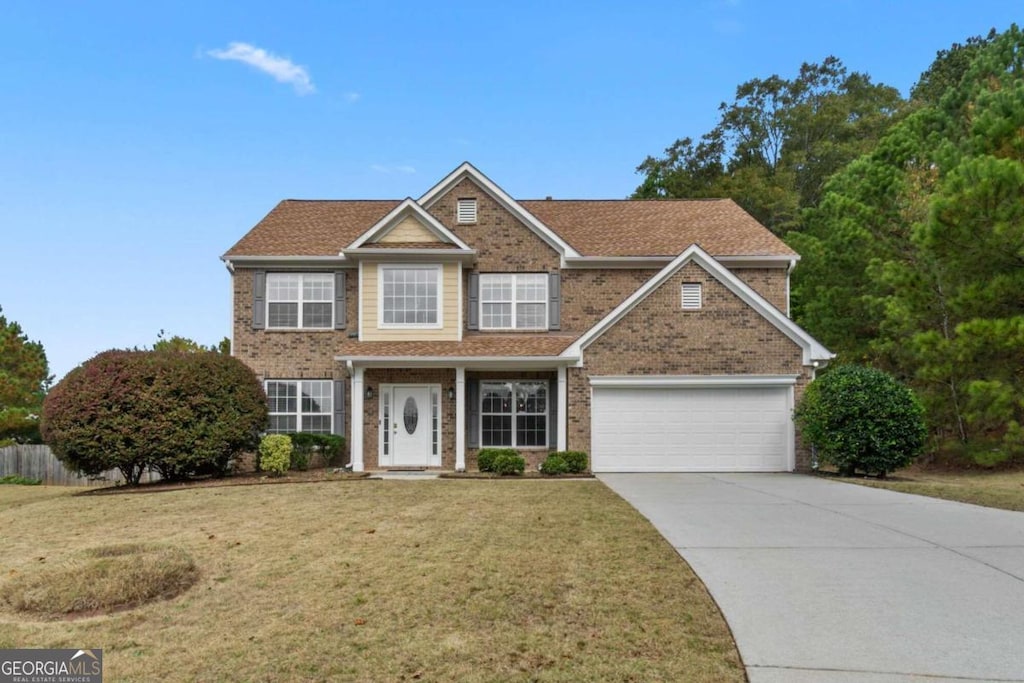 view of front facade featuring a front lawn and a garage