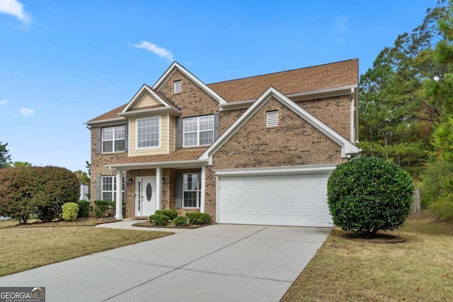 view of front facade featuring a front yard and a garage