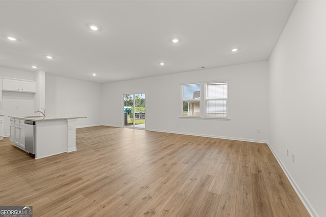 unfurnished living room with sink and light wood-type flooring