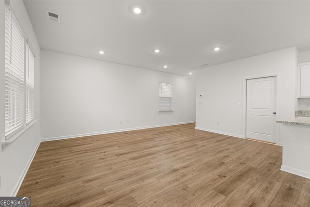 empty room with light hardwood / wood-style floors