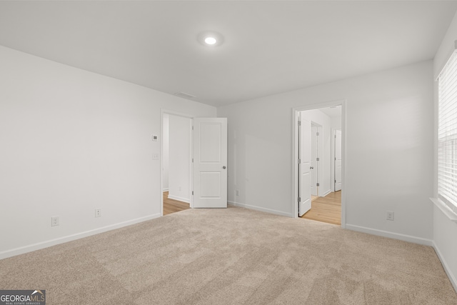 unfurnished bedroom featuring light colored carpet