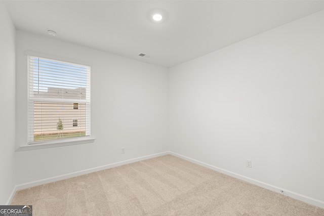 spare room with light colored carpet