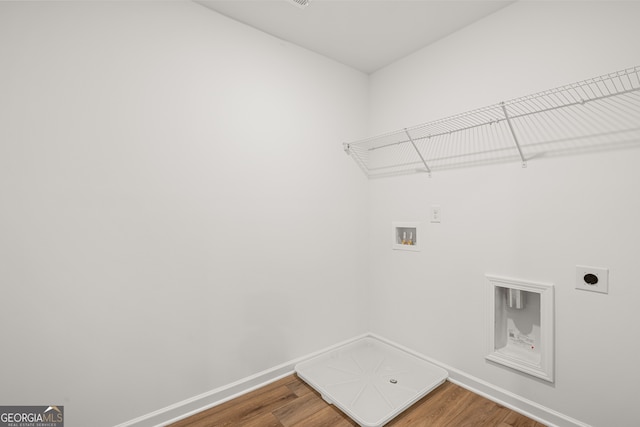 laundry area featuring hookup for an electric dryer, hardwood / wood-style floors, and washer hookup