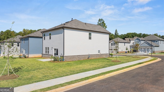 view of home's exterior featuring a garage and a lawn