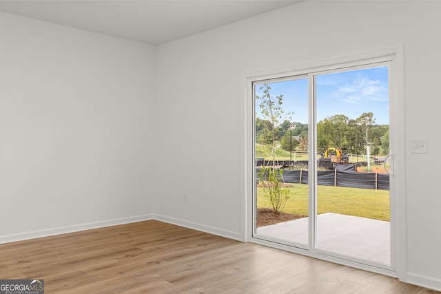 spare room featuring light hardwood / wood-style flooring