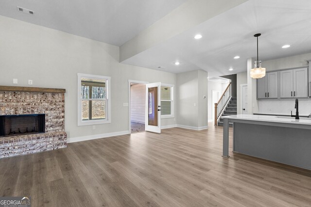 unfurnished living room with light hardwood / wood-style floors and ceiling fan