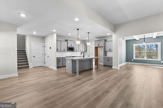 unfurnished living room featuring lofted ceiling, a brick fireplace, wood-type flooring, and ceiling fan