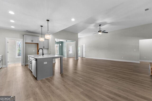 bathroom featuring a wealth of natural light, vanity, and plus walk in shower