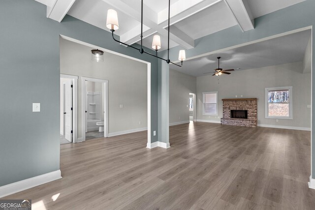 kitchen with gray cabinetry, appliances with stainless steel finishes, hanging light fixtures, ceiling fan, and a kitchen island with sink