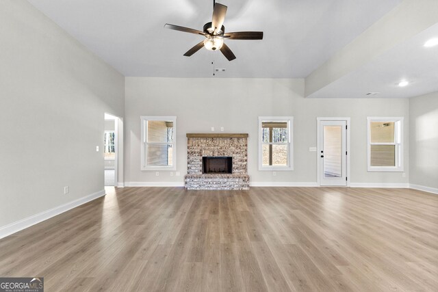 unfurnished living room featuring wood-type flooring and ceiling fan with notable chandelier