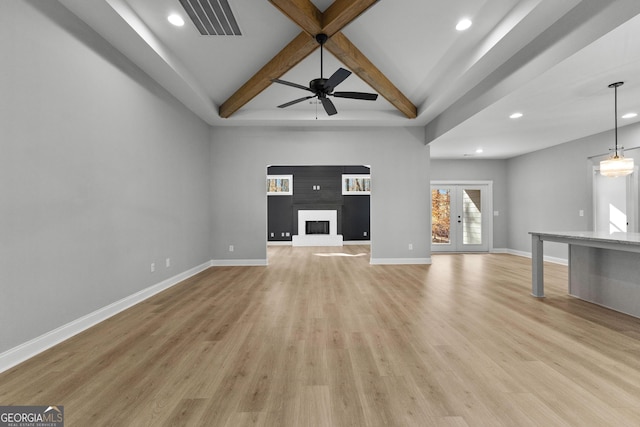 unfurnished living room featuring beam ceiling, french doors, light hardwood / wood-style floors, and ceiling fan