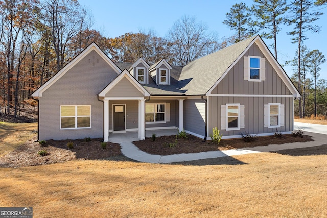 view of front of house with a front lawn and a porch