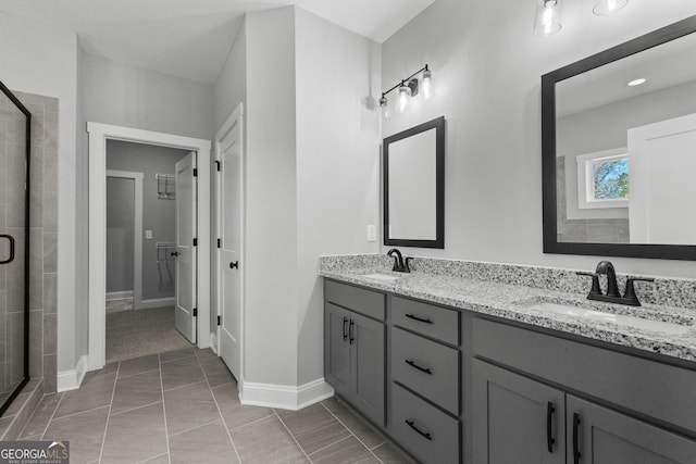 bathroom with tile patterned flooring, vanity, and a shower with shower door