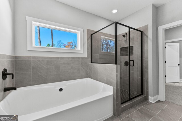 bathroom featuring separate shower and tub and tile patterned floors