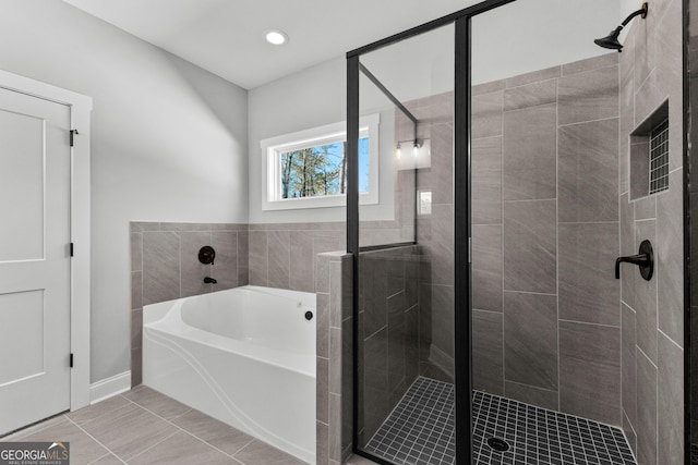 bathroom with tile patterned flooring and plus walk in shower