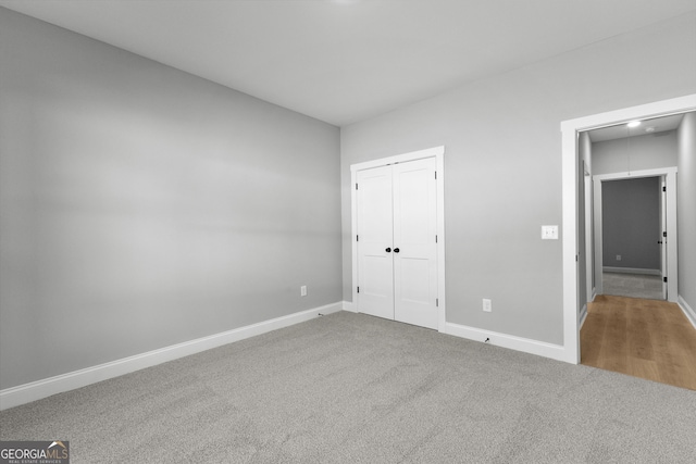 unfurnished bedroom with carpet and a closet