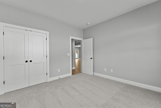 unfurnished bedroom with carpet and a closet