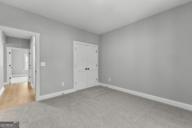 unfurnished bedroom with carpet and a closet