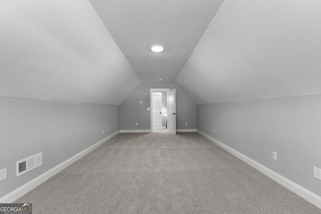 additional living space with light carpet and lofted ceiling