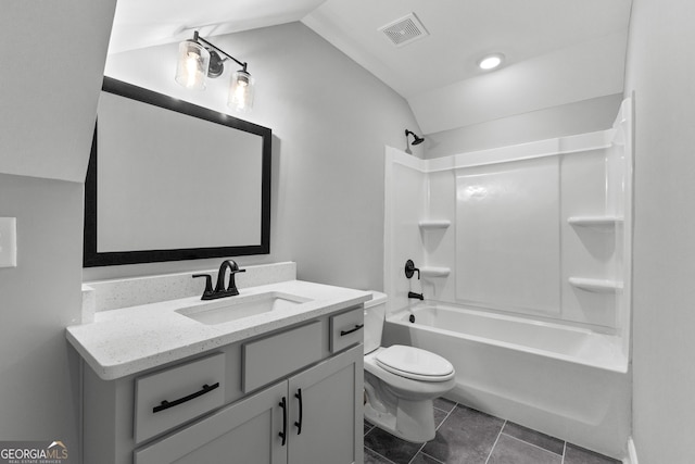 full bathroom with vanity, bathtub / shower combination, tile patterned floors, vaulted ceiling, and toilet