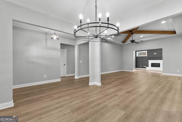 unfurnished living room featuring ceiling fan with notable chandelier, beam ceiling, and light wood-type flooring