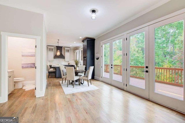 unfurnished dining area featuring french doors and light hardwood / wood-style flooring