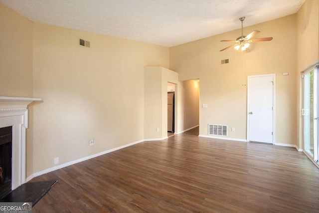 unfurnished living room featuring a textured ceiling, ceiling fan, high vaulted ceiling, and dark hardwood / wood-style flooring