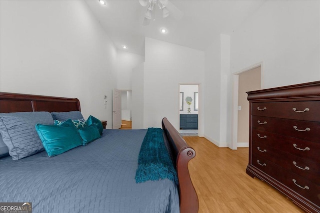 bedroom featuring high vaulted ceiling, recessed lighting, connected bathroom, light wood finished floors, and baseboards