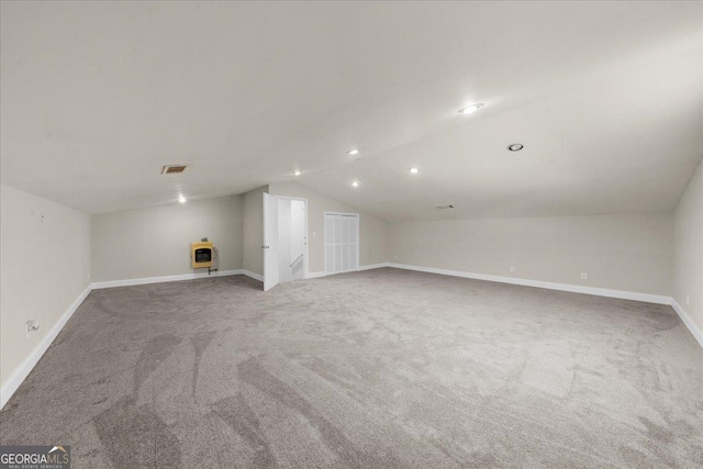 additional living space with lofted ceiling, carpet flooring, baseboards, and visible vents