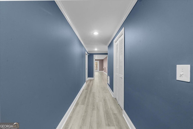 hallway with crown molding, baseboards, and wood finished floors