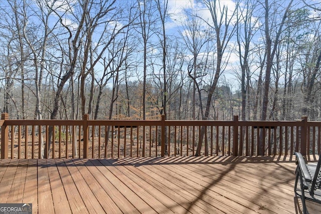 wooden deck with a view of trees