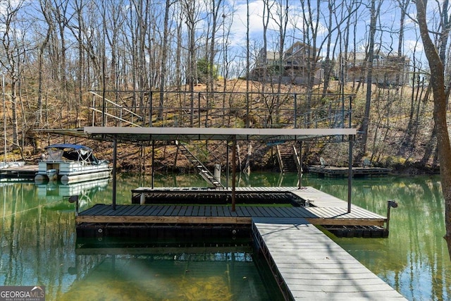 dock area featuring a water view and stairs
