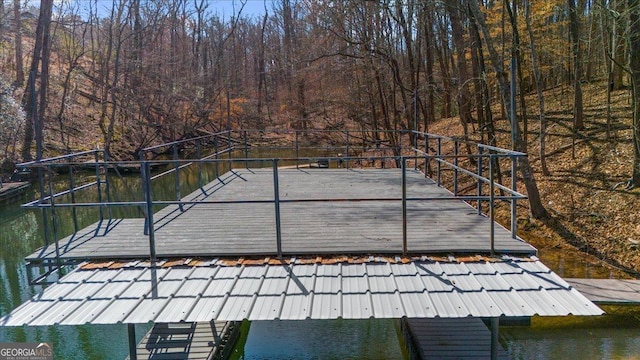 dock area with a water view and a wooded view