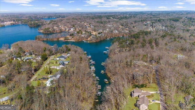 aerial view featuring a forest view and a water view