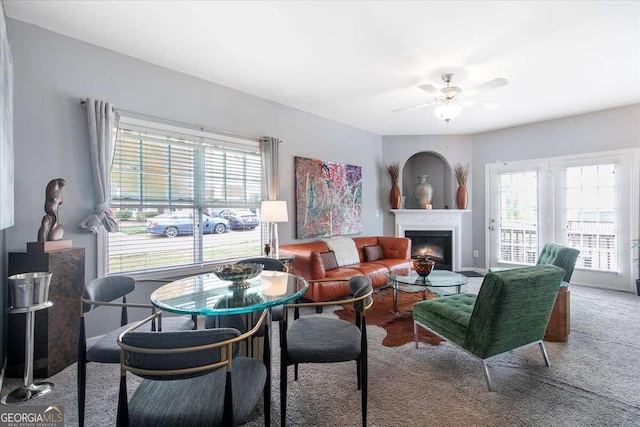 living room with a wealth of natural light and ceiling fan