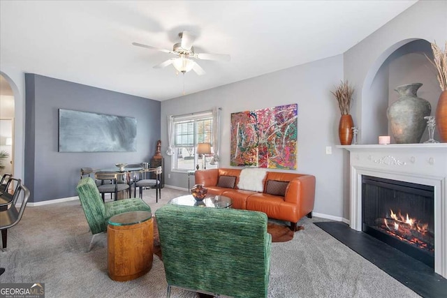 carpeted living room with ceiling fan